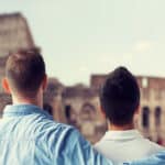 close up of male gay couple over coliseum in rome