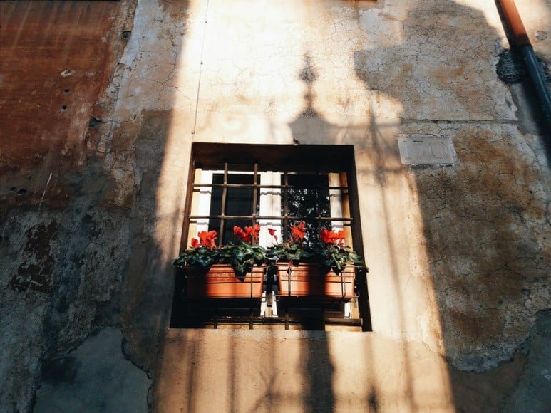 Warm glow of the setting sun on a Roman window