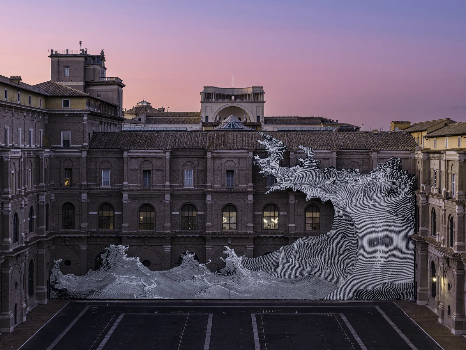 JR’s Diluvium, a giant black and white wave installation covering the facade of the Vatican Apostolic Library courtyard at sunset